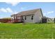 View of backyard with deck, fire pit, shed, and lush green grass, creating a peaceful outdoor space at 1105 Wild Ridge Blvd, Brownsburg, IN 46112