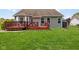 View of backyard and deck with fire pit, perfect for outdoor gatherings; includes a shed for extra storage at 1105 Wild Ridge Blvd, Brownsburg, IN 46112