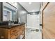 Charming bathroom with a granite countertop, wooden vanity, and a walk-in shower at 1105 Wild Ridge Blvd, Brownsburg, IN 46112