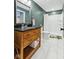 Bathroom featuring a wood vanity with a dark granite countertop and white marble floors at 1105 Wild Ridge Blvd, Brownsburg, IN 46112