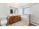 Well-lit bathroom features a double vanity sink, soaking tub, and glass enclosed shower at 1105 Wild Ridge Blvd, Brownsburg, IN 46112