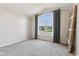 Light-filled bedroom featuring a large window with neighborhood views, carpeting, and neutral colors at 1105 Wild Ridge Blvd, Brownsburg, IN 46112