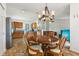 Open concept features a dining area with wooden table, adjoining kitchen, and bright living room at 1105 Wild Ridge Blvd, Brownsburg, IN 46112