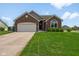 Charming brick ranch home with a well-manicured lawn and attached two car garage at 1105 Wild Ridge Blvd, Brownsburg, IN 46112