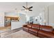Open-concept living area with a cozy fireplace and a view into the kitchen at 1105 Wild Ridge Blvd, Brownsburg, IN 46112