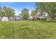 Expansive backyard view featuring play set, trampoline, fenced yard, and storage shed at 1106 Fox Trail W Dr, New Palestine, IN 46163