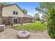 Spacious backyard featuring a fire pit, playset, and a home with a sliding door at 1106 Fox Trail W Dr, New Palestine, IN 46163