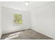Cozy bedroom featuring neutral carpet and a window overlooking the outdoor scenery at 1106 Fox Trail W Dr, New Palestine, IN 46163