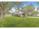 A view of the home highlighting the long driveway and lawn at 1106 Fox Trail W Dr, New Palestine, IN 46163