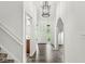 Welcoming foyer with hardwood floors, stylish lighting, and a view of the front door at 1106 Fox Trail W Dr, New Palestine, IN 46163