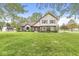Spacious front yard with mature trees surrounding a charming two-story home at 1106 Fox Trail W Dr, New Palestine, IN 46163