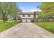 Exterior shot of the home's garage with space for two cars and a long driveway at 1106 Fox Trail W Dr, New Palestine, IN 46163