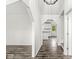 Bright hallway featuring hardwood floors and leading to an open kitchen area at 1106 Fox Trail W Dr, New Palestine, IN 46163