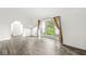Bright living room with hardwood floors, large window, and arched doorway at 1106 Fox Trail W Dr, New Palestine, IN 46163