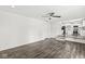 Open living room featuring wood floors and natural light, steps lead to the adjacent kitchen at 1106 Fox Trail W Dr, New Palestine, IN 46163