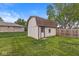 Backyard outbuilding perfect for storage with a small yard and fence at 1106 Fox Trail W Dr, New Palestine, IN 46163