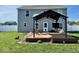 Backyard view of the home featuring a deck with a pergola and a well-maintained lawn at 1112 W Nature Pointe Ln, Muncie, IN 47304
