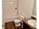 Standard bathroom featuring white fixtures, wood-look vinyl floors and a shower-tub combo at 1112 W Nature Pointe Ln, Muncie, IN 47304