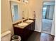 Well-lit bathroom with dual sinks and a vanity, leading to carpeted bedroom at 1112 W Nature Pointe Ln, Muncie, IN 47304