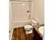 Standard bathroom featuring white fixtures, wood-look vinyl floors and a shower-tub combo at 1112 W Nature Pointe Ln, Muncie, IN 47304