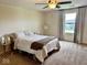 Cozy bedroom with a ceiling fan, natural light, and neutral decor, creating a relaxing atmosphere at 1112 W Nature Pointe Ln, Muncie, IN 47304