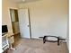 Bedroom with neutral walls, carpet, and a doorway to the upper landing at 1112 W Nature Pointe Ln, Muncie, IN 47304