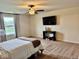 This spacious bedroom is equipped with a ceiling fan and a wall-mounted television at 1112 W Nature Pointe Ln, Muncie, IN 47304