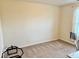 Bedroom with neutral walls and carpet featuring a nearby window at 1112 W Nature Pointe Ln, Muncie, IN 47304