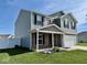 Two-story home with gray siding, brick accents, manicured lawn, and an attached two-car garage at 1112 W Nature Pointe Ln, Muncie, IN 47304
