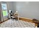 Bright home office with a modern desk, comfortable chair, and large window with natural light at 1112 W Nature Pointe Ln, Muncie, IN 47304