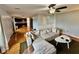 Open living room features hardwood floors, a ceiling fan, neutral paint and access to kitchen at 1112 W Nature Pointe Ln, Muncie, IN 47304
