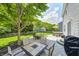 The backyard has a seating area with a fire pit, a dining table, and a hot tub, great for relaxation at 11121 Godfrey Dr, Noblesville, IN 46060