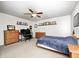 Bedroom featuring carpeted floors, neutral walls, a ceiling fan, and a cozy bed with a plush blue blanket at 11121 Godfrey Dr, Noblesville, IN 46060