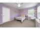 Bedroom featuring light purple walls, carpeted floors, a ceiling fan, and cozy, patterned bedding at 11121 Godfrey Dr, Noblesville, IN 46060