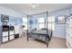 A charming bedroom with light blue walls, large windows, and a cozy bed with unique canopy frame at 11121 Godfrey Dr, Noblesville, IN 46060