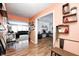 Open foyer flows into living room, featuring decorative shelves and a view to the office at 11121 Godfrey Dr, Noblesville, IN 46060