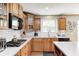 Well-lit kitchen features stainless appliances, white countertops, and ample wooden cabinetry at 11121 Godfrey Dr, Noblesville, IN 46060