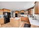 Beautiful kitchen with warm wood cabinets, stainless appliances, and an island for extra workspace at 11121 Godfrey Dr, Noblesville, IN 46060