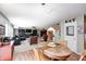 Open eat-in kitchen with wooden table and chairs connects to the Gathering and living rooms at 11121 Godfrey Dr, Noblesville, IN 46060