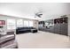 Spacious living room with plush seating, a ceiling fan, and large windows for natural light at 11121 Godfrey Dr, Noblesville, IN 46060
