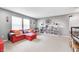 Spacious living room featuring a comfortable red sofa and built-in bookshelves at 11121 Godfrey Dr, Noblesville, IN 46060