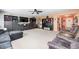 Cozy living room featuring dark furnishings, plush sofas, carpet, and an open view to the front door at 11121 Godfrey Dr, Noblesville, IN 46060