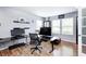 Office space with laminate floors, two windows for natural light, and ample desk space at 11121 Godfrey Dr, Noblesville, IN 46060