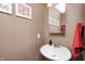Charming powder room features a pedestal sink, decorative mirror, and warm-toned walls at 11121 Godfrey Dr, Noblesville, IN 46060