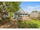 Backyard with patio and covered porch, and blue painted exterior siding at 1215 N Pershing Ave, Indianapolis, IN 46222