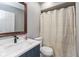 Bathroom with updated marble vanity, matte black faucet, decorative mirror, and shower at 1215 N Pershing Ave, Indianapolis, IN 46222