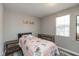 Bright bedroom features a single bed, laminate floors, dresser, and natural light at 1215 N Pershing Ave, Indianapolis, IN 46222
