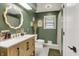 Stylish bathroom features a modern vanity with a beautiful mirror and complementary fixtures at 1225 N Graham Ave, Indianapolis, IN 46219