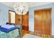 Charming bedroom with hardwood floors and a unique decorative light fixture at 1225 N Graham Ave, Indianapolis, IN 46219