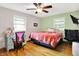 Comfortable bedroom featuring hardwood floors, a ceiling fan, and a calming color scheme at 1225 N Graham Ave, Indianapolis, IN 46219